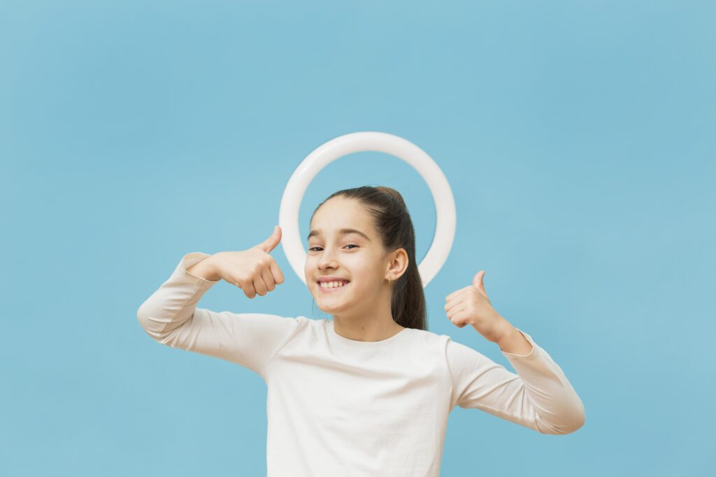 portrait positive young girl showing thumbs up